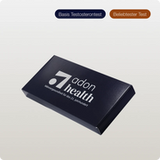 A dark blue box labeled “Dummy Testosteron Test” with German text below, displayed on a light gradient background. Two buttons above read Basis Testosterontest and Beliebtester Test in German.